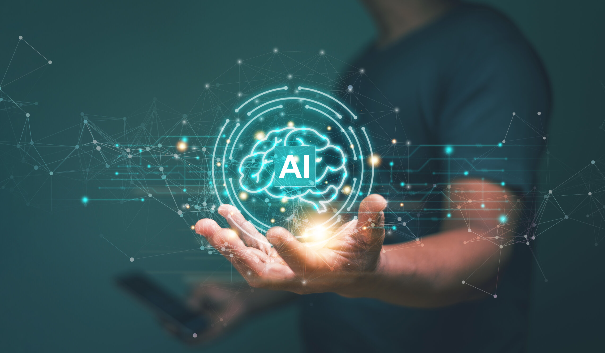 Artificial intelligence and machine learning concept with human hand holding AI brain